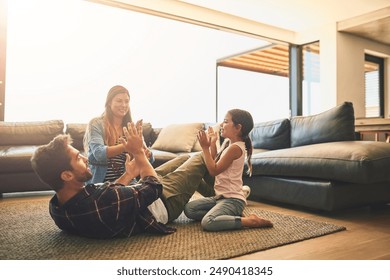 Clapping, playing and family with game in home for bonding together on floor for child development. Weekend, happy and girl kid having fun with parents on carpet in living room at house in Canada. - Powered by Shutterstock