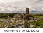 Claregalway Friary. Ireland. Front of abbey with gravestones. Wide angle.	