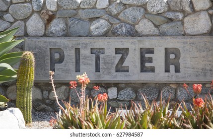 Claremont, CA, USA - April 14, 2017: The Sign For Pitzer College, A Liberal Arts College In Southern California Just Outside Of Los Angeles.