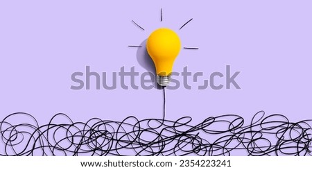 Clarifying complex ideas theme with light bulb - Flat lay