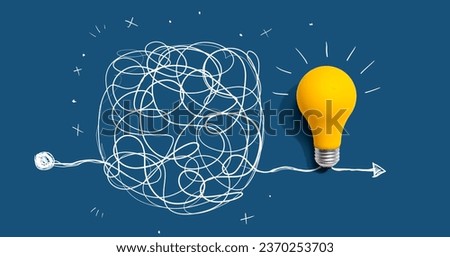 Clarifying complex ideas theme with light bulb - Flat lay