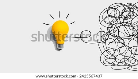 Clarifying complex ideas theme with light bulb - Flat lay