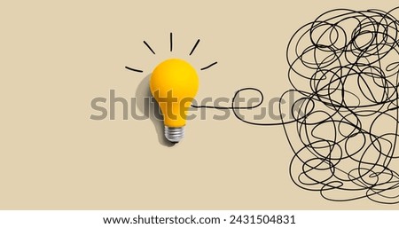 Clarifying complex ideas theme with light bulb - Flat lay