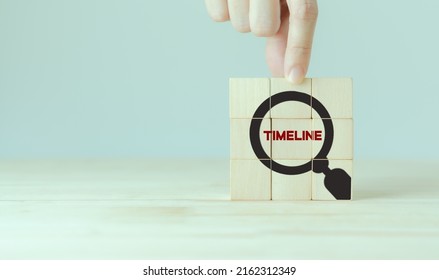 Clarifying project timeline concept. Project management, scheduling, milestones setting. Wooden cubes with magnifyier timeline text icon on grey background. Project planning presentation.