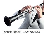 Clarinet player. Clarinetist hands playing woodwind instrument isolated on white. Musical instruments closeup