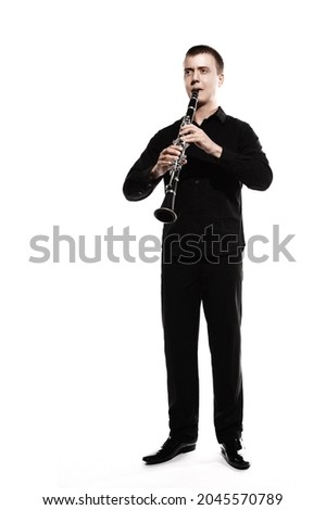 Clarinet player classical musician isolated on white background. Clarinetist man playing musical woodwind instrument