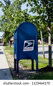 Clarion, Pennsylvania / USA - June 29, 2018: USPS Mailbox Beside Sidewalk