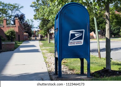 Clarion, Pennsylvania / USA - June 29, 2018: USPS Mailbox Beside Sidewalk