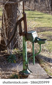 Clark Mills, WI  USA December 1 2020: Old Historic Hand Water Pump On The Edge Of The Forest