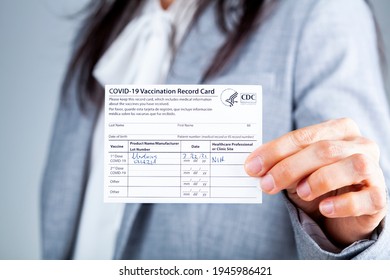 Clarksburg, MD, USA 03-29-2021: A Caucasian Businesswoman Is Showing Her CDC Issued COVID Vaccination Record Card As A Proof Of Immunization. It Has The Date And Lot Number On It.