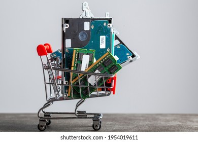 Clarksburg, MD, USA 04-09-2021: Small Shopping Cart Filled With Computer Parts Including RAM Memory Cards And A Hard Drive. Shopping For Technology, Consumer Electronics, Upgrading Computer Themes.