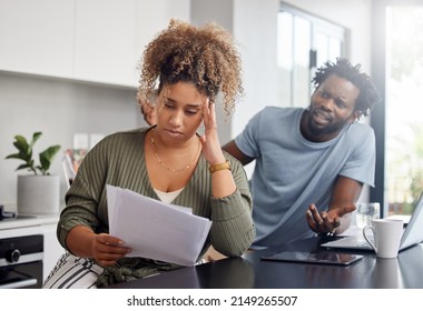 A Clash Of Cultures. Shot Of A Couple Having An Argument While Going Over Their Finances At Home.