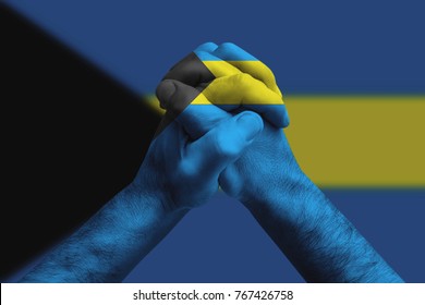 Clasped hands patterned with the Bahamas flag, multi purpose concept - isolated on flag background