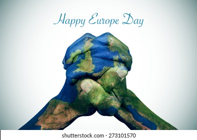 the clasped hands of a young man patterned with a europe map (furnished by NASA) and the text happy europe day - Shutterstock ID 273101570