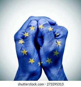 the clasped hands of a young man patterned with the flag of the european union - Shutterstock ID 273295313