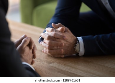Clasped male hands of two businessmen negotiate at table, hr recruiter making hiring decision at difficult job interview, opponents dialogue debate, business confrontation challenge concept, close up - Shutterstock ID 1289761681