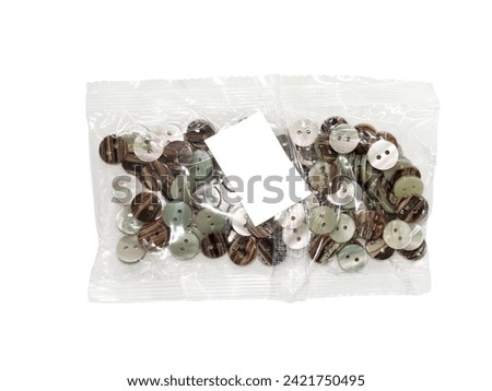 clasper , colored plastic Buttons in a clear plastic bag isolated on white background.