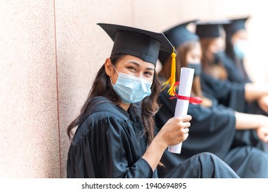 The Class Of 2021,group Of Graduates Asian Student Wear A Mask At A Distance At The Graduation Ceremony At The University