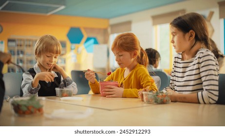 Class of Adorable Diverse Children Having a Lunch Break with Healthy Vegetarian Meals in an International Primary School. Young Kids Enjoying Their Time, Having Fun Conversations while Eating Food - Powered by Shutterstock