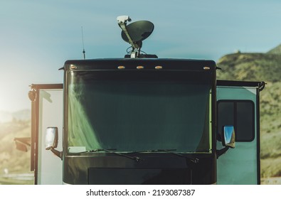 Class A Diesel Pusher With On Roof Satellite TV Dish Installed. Watching Television While On A Road. 