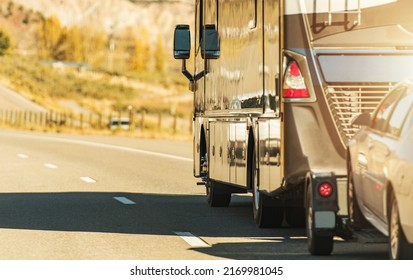 Class A Diesel Pusher Recreational Vehicle. RV Motor Coach with Pull Vehicle on a Highway. Travel in a Motorhome. - Shutterstock ID 2169981045