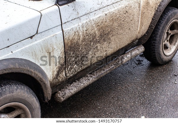 Class dirt from the wheels of\
the car. Stick to a white car Due to the road in the rainy\
season