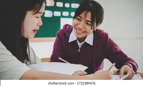 Class In School Of Asian Students Learning Homework On Table In Classroom, Front Green Whiteboard At College In High School Of Asia, Happy In Education Study To Learn With Teamwork Concept