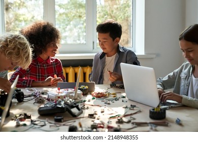 Class In School Lab For Group Of Multiracial Diverse Schoolkids Interacting Using Gadgets For Building Engineering Robots. Elementary Science Classroom Of Ai Technologies. STEM Education Concept.