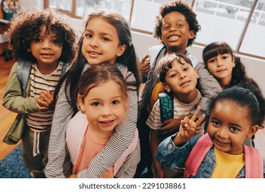 Class selfie in an elementary school. Kids taking a picture together in a co-ed school. Group of elementary school children feeling excited to be back at school. - Powered by Shutterstock