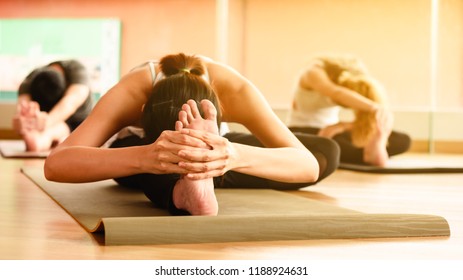 Class Of Yoga With Multi Nation People Student Streching Back And Legs