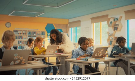 Class of Young Multiethnic Children Using Laptop Computers while Studying STEM and Information Technology Disciplines in Grade School. Happy Female Teacher Educating Smart Boys and Girls - Powered by Shutterstock - Get 15% off with code: PIKWIZARD15