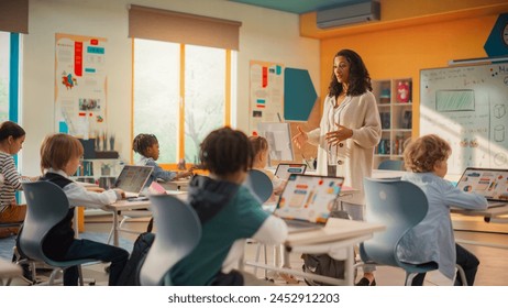 Class of Young Multiethnic Children Using Laptop Computers while Studying Math and Geometry in Grade School. Happy Female Teacher Explains Shapes and Measurements to Smart Boys and Girls - Powered by Shutterstock