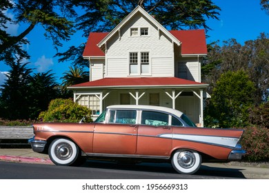 Classic 1957 Chevrolet Bel Air Four Door Sedan Parked On On The Street In Front Of Eclectic Queen Anne Architecture Style Historic Building - San Francisco, California, USA - 2021