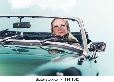 Classic 1960s Fashion Woman With Headscarf Driving Sports Car.