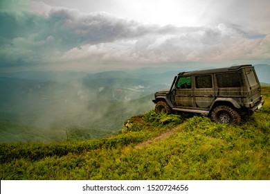 Classic 4x4 Car Crossing Water With Splashes On Muddy Road. Water Splash In Off Road Racing. Truck Car Wheel On Offroad Steppe Adventure Trail