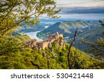 Classic aerial view of historic Aggstein castle ruin with famous Danube river in the background in beautiful golden evening light at sunset in summer, Wachau valley, Lower Austria region, Austria