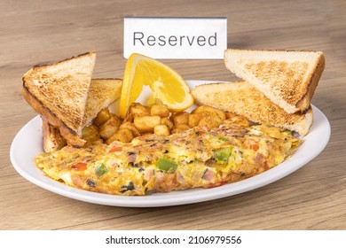 A Classic American Diner Breakfast With A Western Or Denver Omelette, Home Fried Potatoes And Toast On A Table With A Reserved Sign