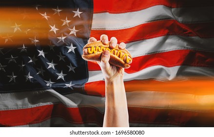 classic american hot dog in hand on american flag background for American Independence Day celebration on July 4 - Powered by Shutterstock