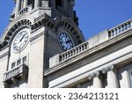 Classic architecture. Clock tower. Roman numerals. Ionic columns. Blue sky. Isolated. Detail. Former federal post office. New city hall. Early 1900s. Brantford, Ontario, Canada. Heritage. History.