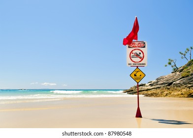 Classic Australian Beach With Warning Flag From Surf Life Savers