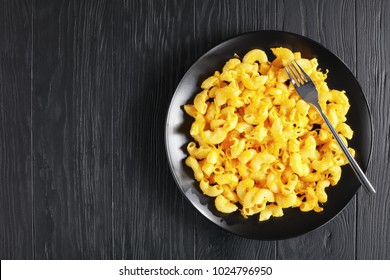 Classic Baked Homemade Macaroni And Cheese On Black Plate With Fork On Dark Wooden Table, View From Above