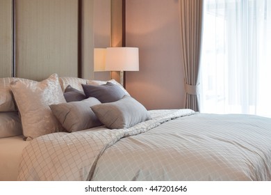 Classic bedroom interior with pillows and reading lamp on bedside table - Powered by Shutterstock