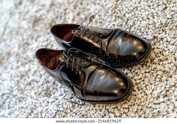 classic black shoe with smooth oxford type laces,\
leather sewn to leather sole with wooden heel, typical groom shoe\
for wedding, used