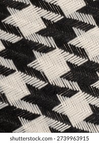 Classic black and white houndstooth pattern texture. Traditional checkered fabric design for textile industry, high-fashion concepts, and retro decorative backgrounds.