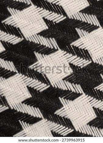 Classic black and white houndstooth pattern texture. Traditional checkered fabric design for textile industry, high-fashion concepts, and retro decorative backgrounds.