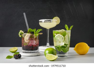 Classic And Blackberry Mojito, Margarita Cocktail With Lime On Black Background. Three Summer Freshness Beverage For Festive Party. Summer Holiday Mocktail.