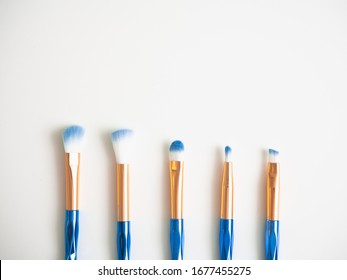 Classic Blue Eyeshadow Brushes Isolated On White Background With Space For Copy Space.