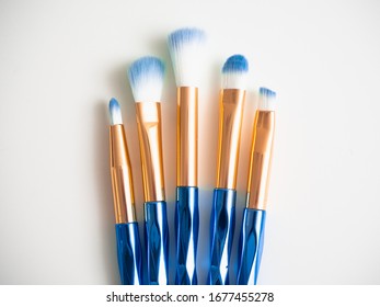 Classic Blue Eyeshadow Brushes Isolated On White Background With Space For Copy Space.