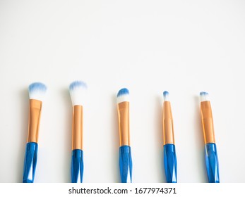 Classic Blue Eyeshadow Brushes Isolated On White Background With Space For Copy Space.