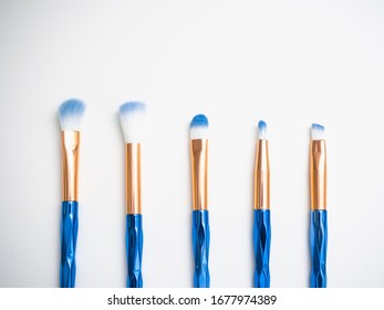 Classic Blue Eyeshadow Brushes Isolated On White Background With Space For Copy Space.